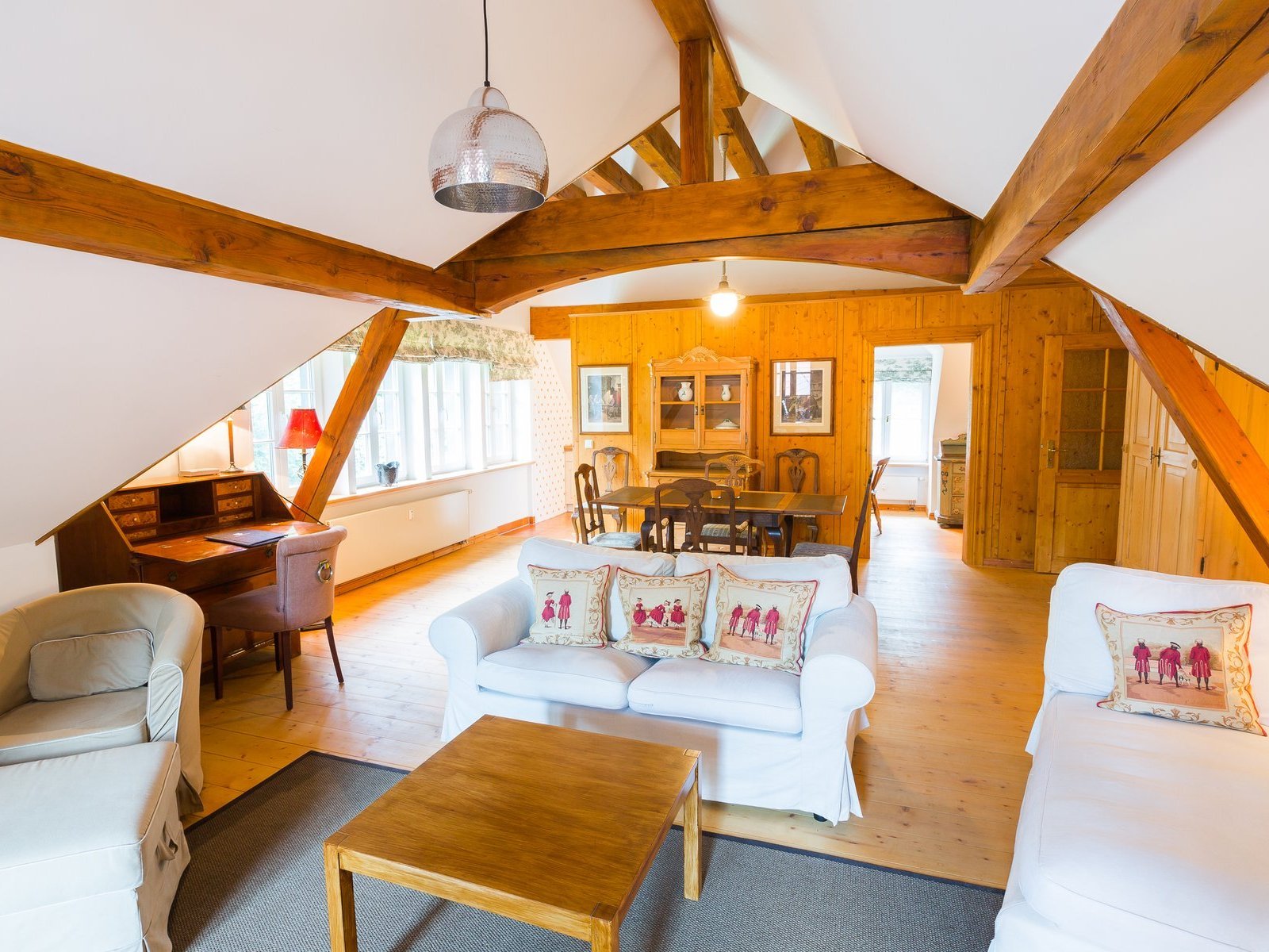 Innenansicht mit Couch, Sessel und Tisch von der Försterwohnung im Forsthaus